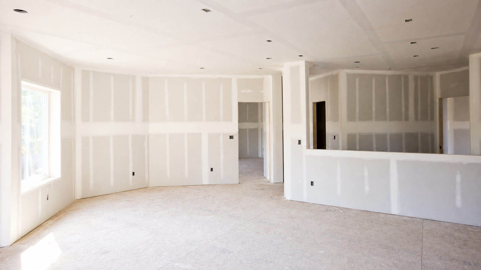 Fresh drywall installation in a clean unfinished room